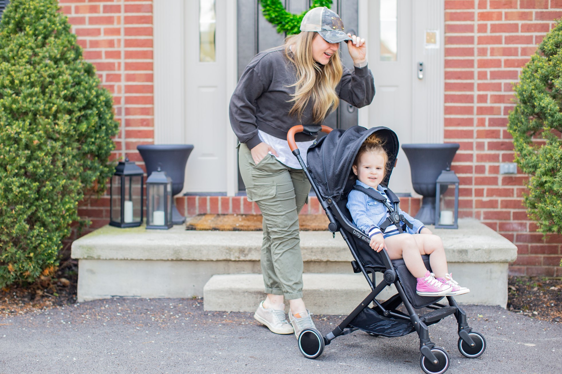 Mom strolling with daughter in the Contours BitsyElite Stroller in Black Onyx
